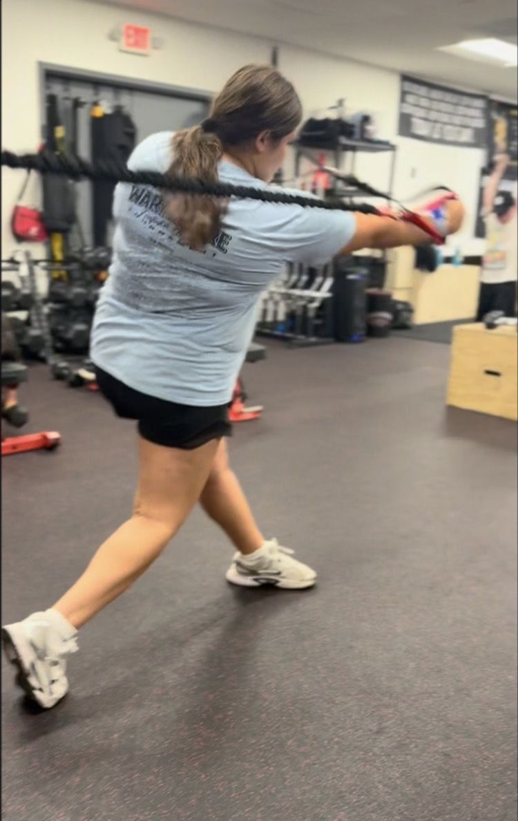 Athlete driving through a rotational rope trainer